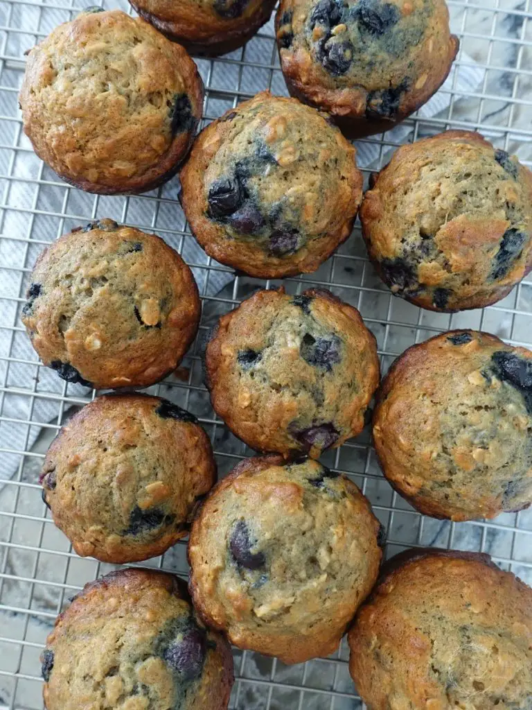 banana blueberry oatmeal muffins cooling on a wire cooling rack