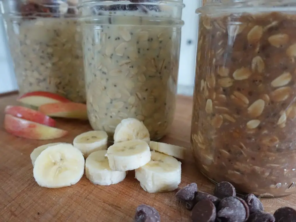 flavor varieties of high protein overnight oats in mason jars and the toppings on the side