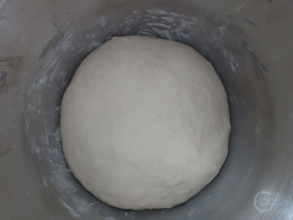 sourdough discard bread dough after proofing in a bowl showing that its doubled in size