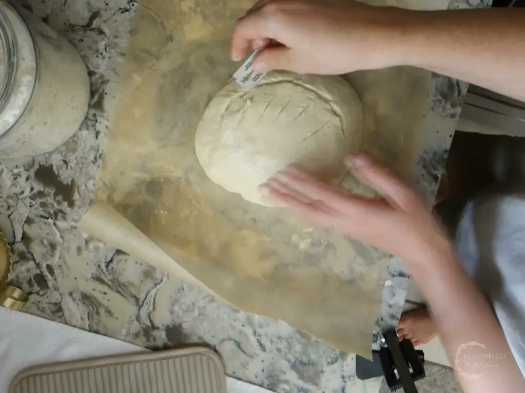 scoring the dough of sourdough discard bread