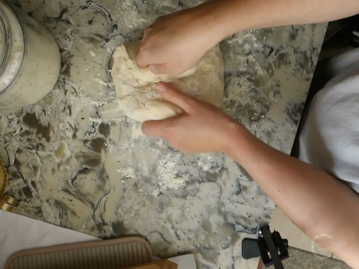 bringing the other side of the dough for shaping