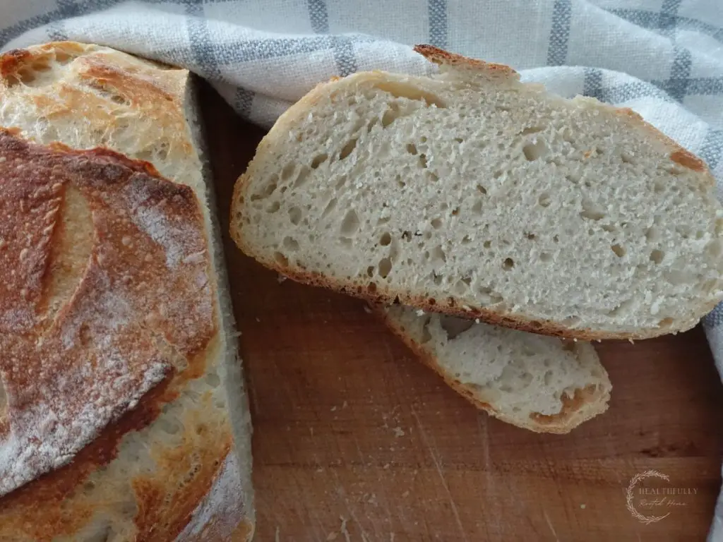 sourdough discard bread with two slices stacked on eachother and the rest of the loaf next to it