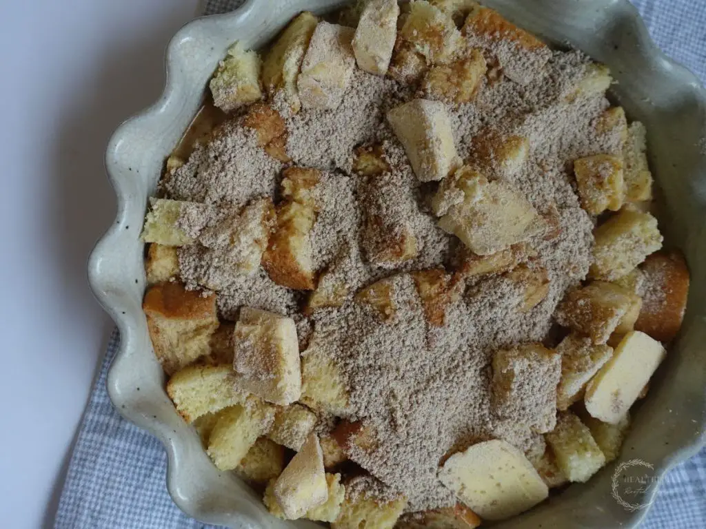 unbaked brioche french toast casserole in a scalloped baking dish