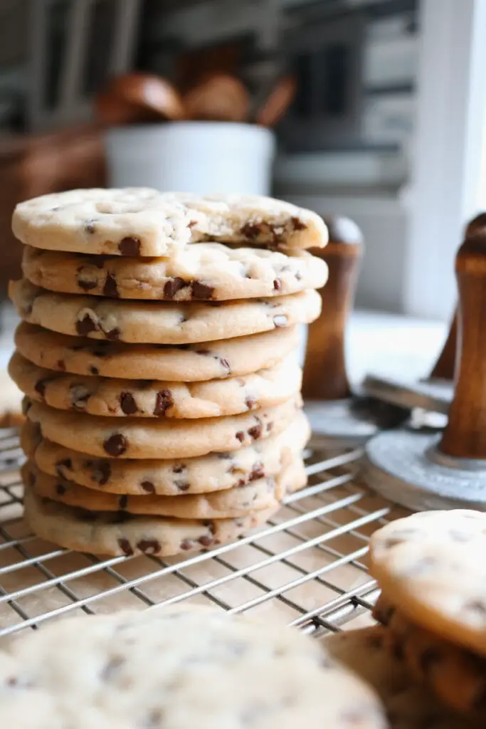 stacked chocolate chip sugar cookies with the top cookie with a bite taken out