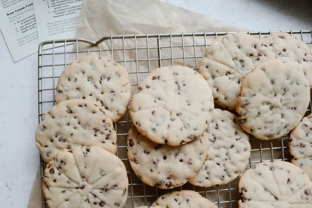 chocolate chip sugar cookies with recipe cards in he background