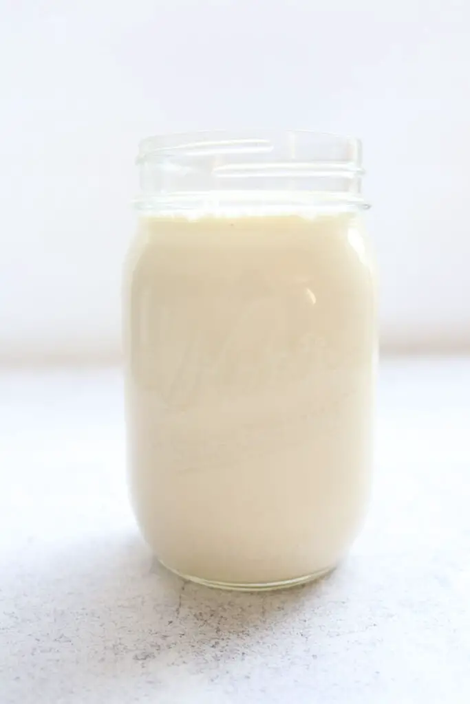 mason jar filled with buttermilk shown as an alternative to applesauce in recipes