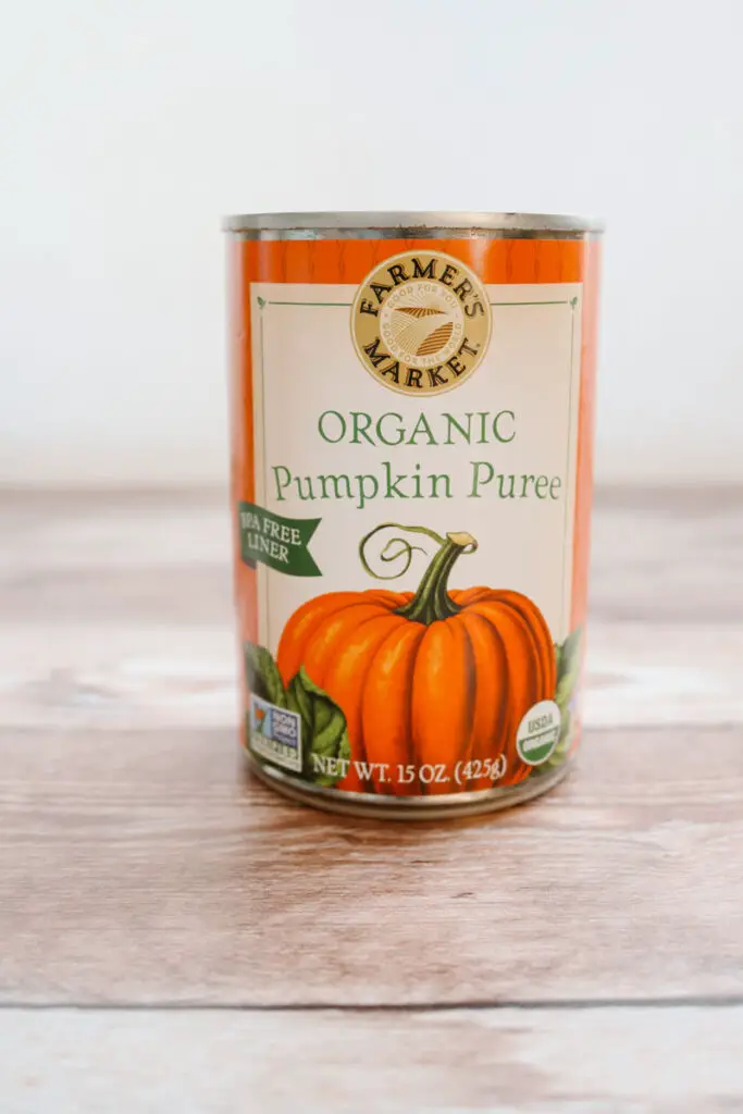 can of organic pumpkin puree being shown as an applesauce replacement for recipes